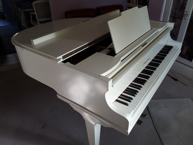 Chappell ivory baby grand piano.