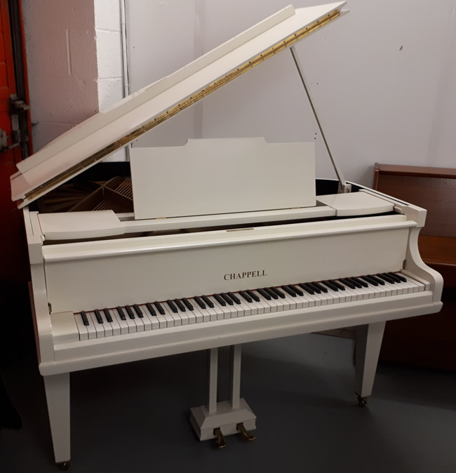 Chappell restored baby grand piano in a Ivory satin finish.