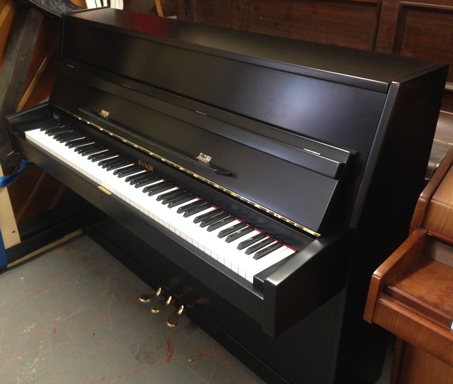 Danor black satin upright piano.