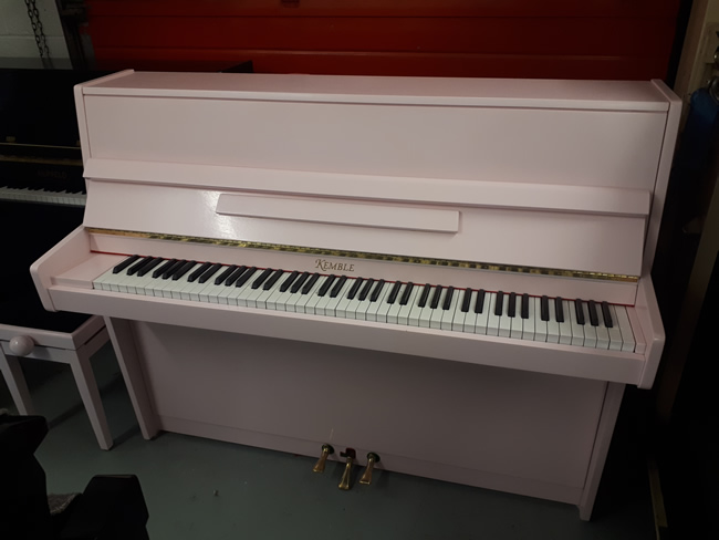 Kemble Pink satin upright pianos.