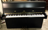 Reid sohn Black upright piano.