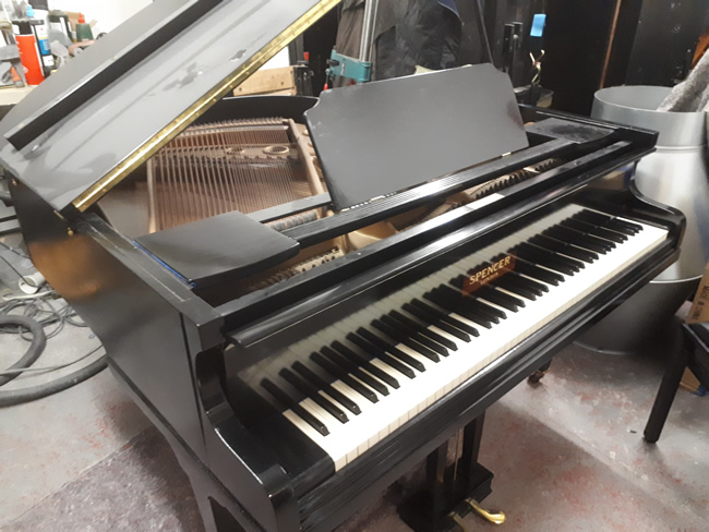 Spencer baby grand piano restored in a black gloss cabinet.