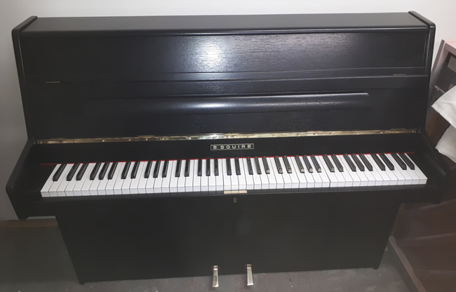 B Squire small upright piano in a Black satin finish.