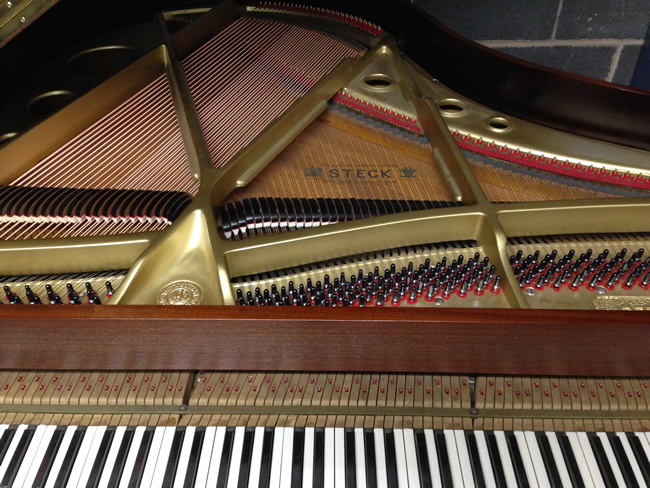Steck baby grand piano refinished frame with new strings pins and dampers.