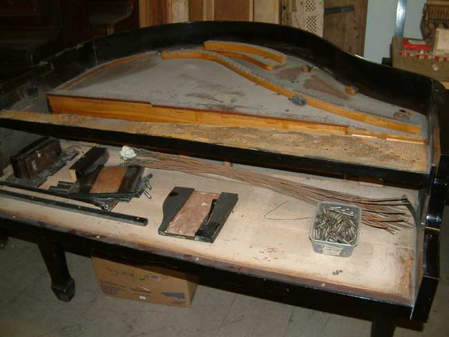 Frame removed from body of piano.