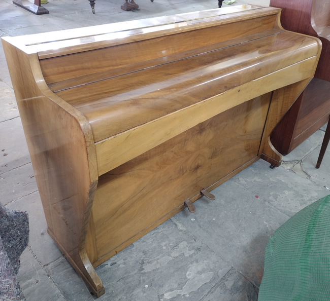 Consolette mini piano in a walnut satin finish.