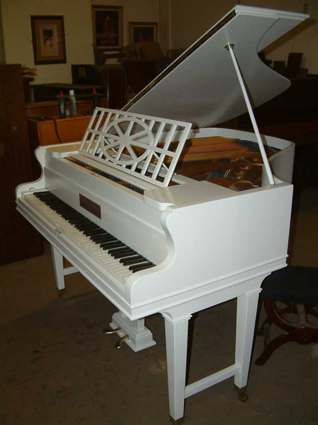 John Brinsmead grand piano in a White cabinet