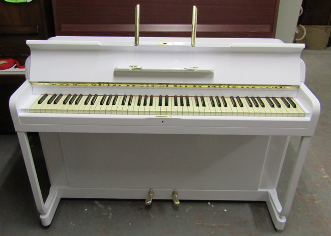 Kemble Minx piano in a white gloss finish.