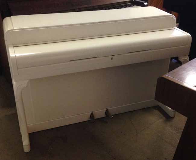 Kemble Minx piano in a white satin finish.