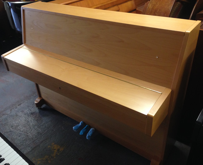 Steinbach Upright Piano in a Beech satin finish.