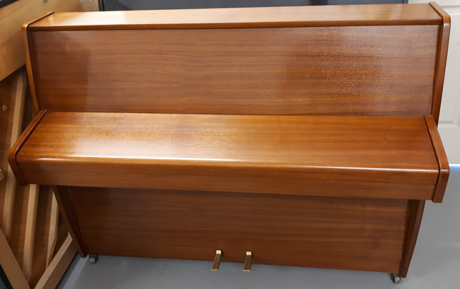 Zender teak satin upright piano frontview.